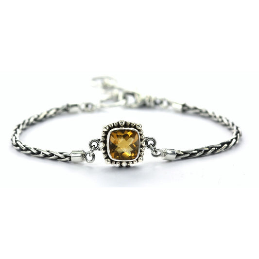 Silver bracelet with wheat chain arms and a citrine gemstone station in the middle.