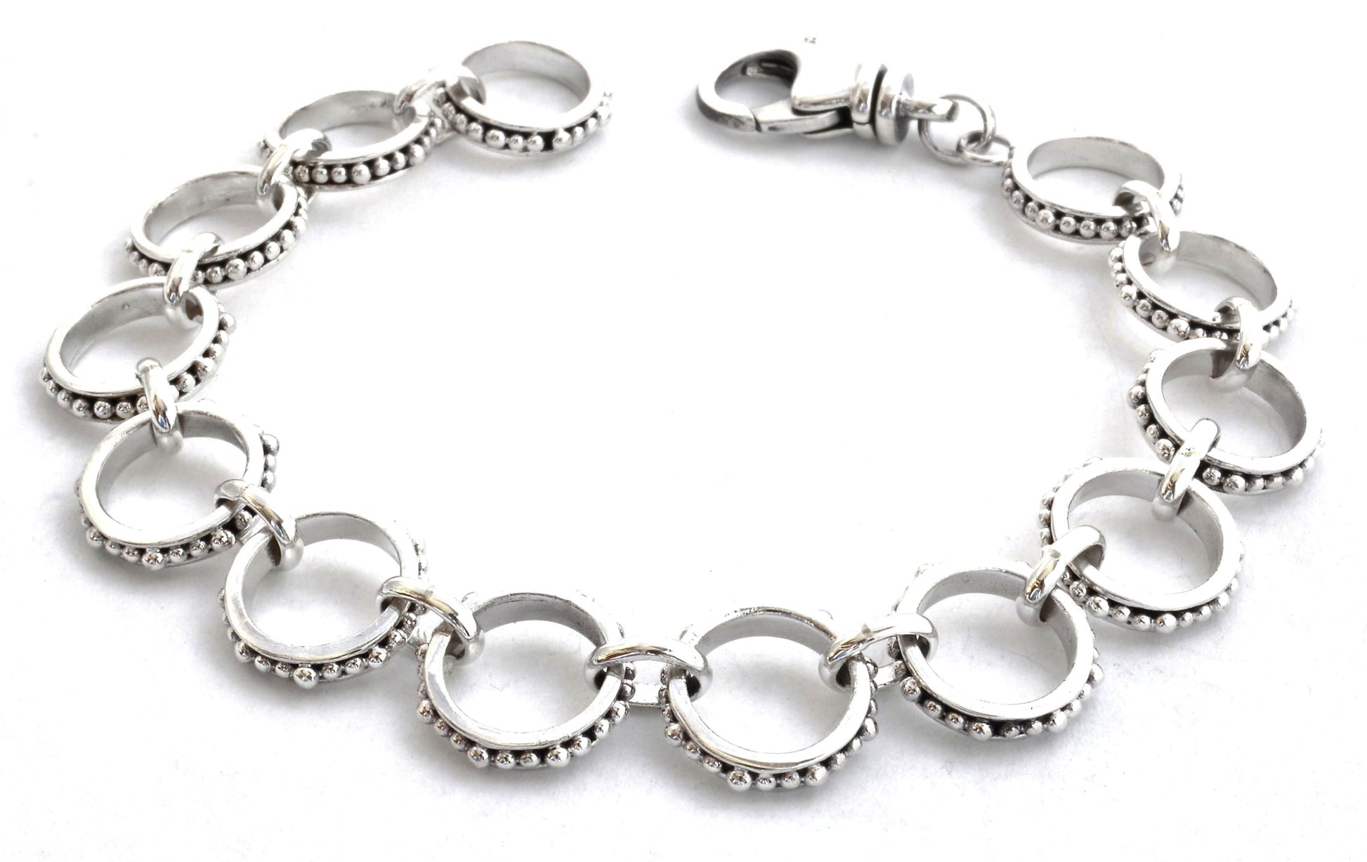 Silver link bracelet with beads around each link.